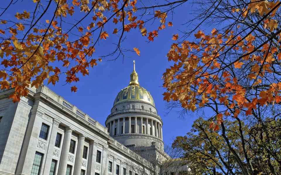 FILE - The West Virginia Capitol with its dome framed by turning sugar maples leaves is seen, Nov. 3, 2014, in Charleston, W.Va. Close to 400 medical professionals in West Virginia have signed onto a letter condemning a bill advancing in the state House of Delegates that would bar transgender youth at risk for suicide from accessing medical interventions like hormone therapy. (Tom Hindman/The Daily Mail via AP, File)