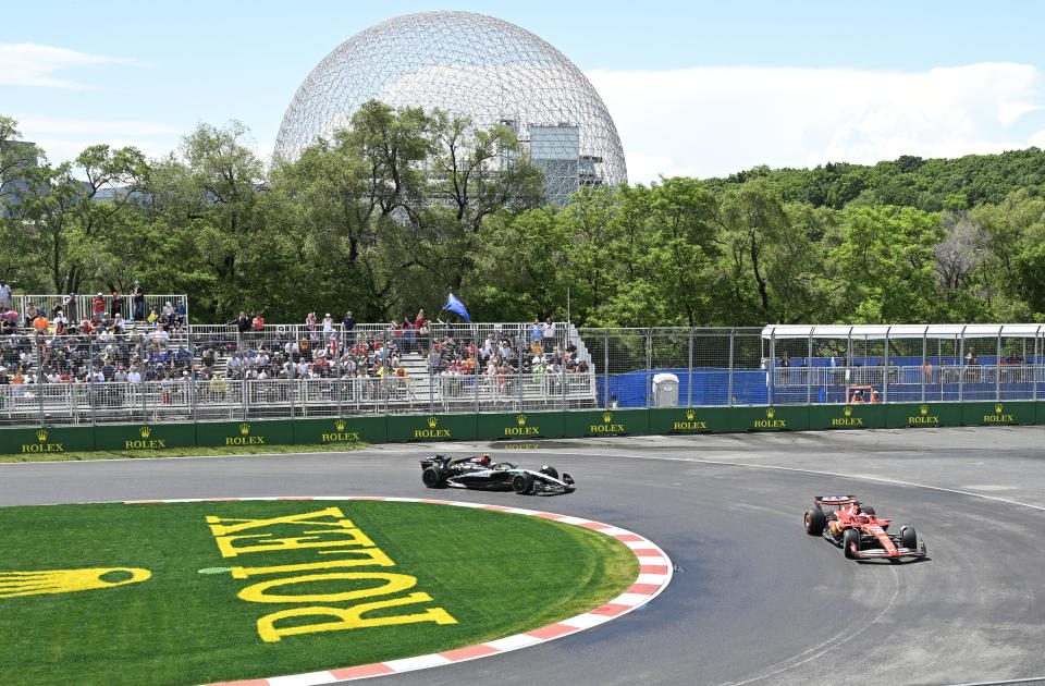 Ferrari driver Charles Leclerc of Monaco, right, and Mercedes driver Lewis Hamilton of Britain steer their car at the hairpin during practice for the Formula 1 Canadian Grand Prix auto race Friday, June 7, 2024, in Montreal. (Jacques Boissinot/The Canadian Press via AP)