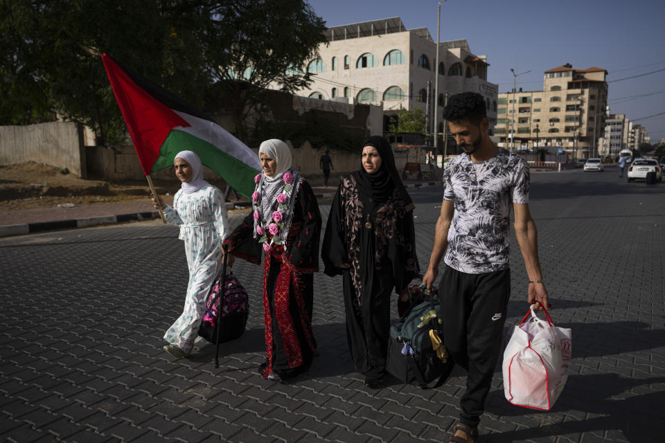 Huda Zaqqout, second left, walks with her relatives as she leaves Gaza City for the Hajj pilgrimage in Mecca, Saudi Arabia, Tuesday, June 13, 2023. (AP Photo/Fatima Shbair)