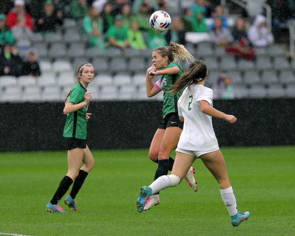 Seton's Rachel Ginn (No. 5) watches as teammate Maria Meade (No. 6) gets a header in front of Strongsville's Alexa Muth during the state Division I OHSAA Championship at Lower.com field on Nov. 11, 2022, in Columbus, Ohio. The Saints defeated Strongsville 1-0 on a rainy, chilly pitch.
