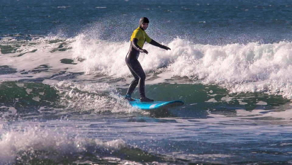 Makenzie Elliott surfs for the first time during a lesson at Newport on Nov 19.