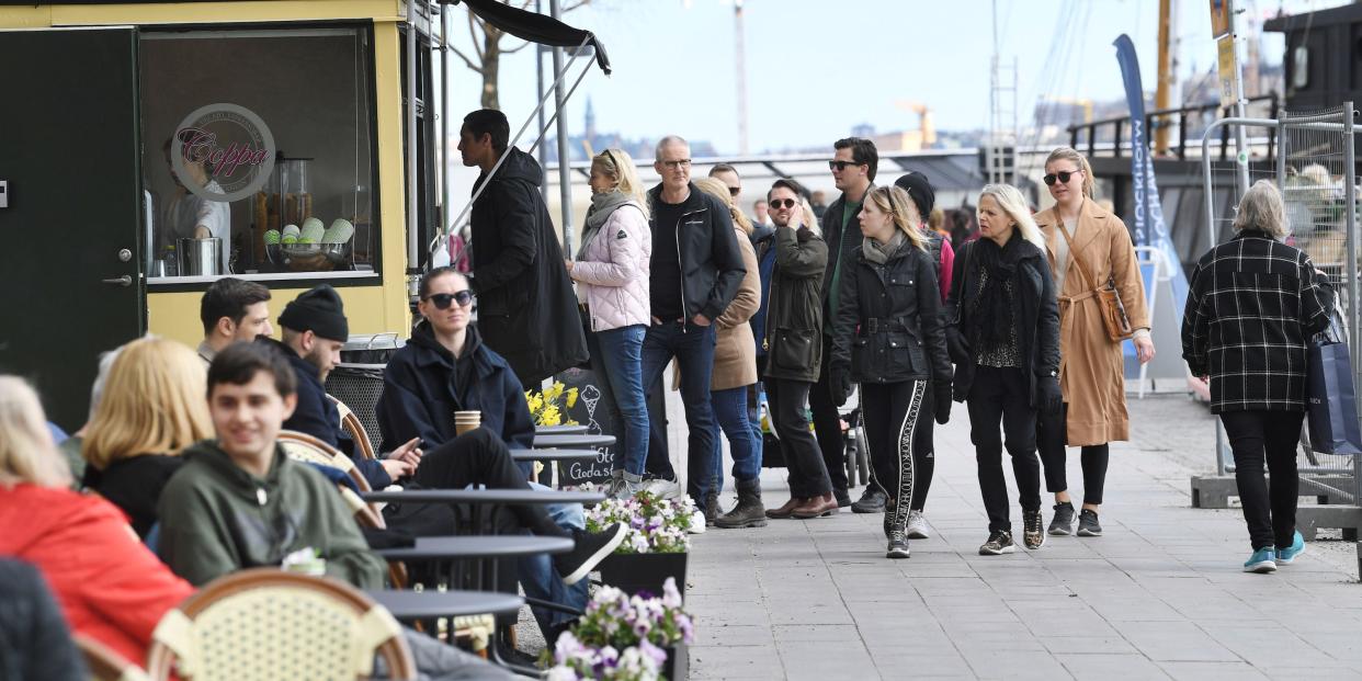 People buy ice cream at Norr Malarstrand during spring weather, amid the coronavirus disease (COVID 19) outbreak, in Stockholm, Sweden, on April 19, 2020.