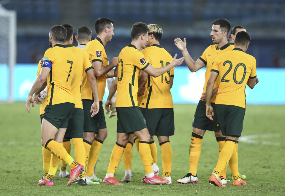 Australia's Ajdin Hrustic, center, celebrates with his teammates after scoring his side's third goal during the World Cup 2022 Group B qualifying soccer match between Kuwait and Australia in Kuwait City, Kuwait, Thursday, June 3, 2021. (AP Photo/Jaber Abdulkhaleg)