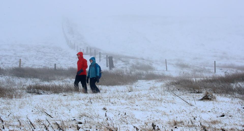 Walkers brave snowy conditions in Macclesfield, Cheshire at the weekend. (PA)