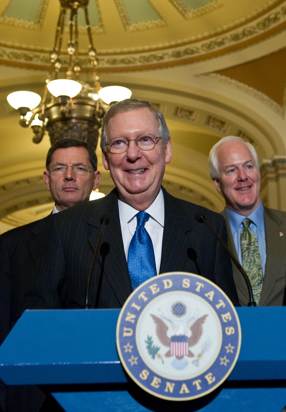 McConnell smiles as he speaks to the press with fellow Republican senators John Barroso of Wyoming and John Cornyn of Texas at the Capitol Aug. 2, 2011. (NICHOLAS KAMM/AFP/Getty Images)