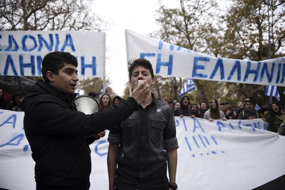 Teenagers shout slogans during a protest in the northern Greek city of Thessaloniki, Thursday, Nov. 29, 2018. About 1,000 high school students protested against government efforts to end a three-decade-old dispute with neighboring Macedonia. The banners read "Macedonia-Greek Land." (AP Photo/Giannis Papanikos)