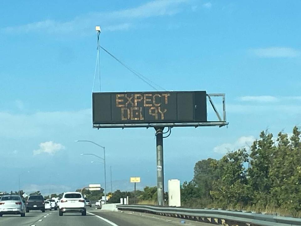 A sign on eastbound Highway 180 approaching Highway 41 warns drivers to expect delays due to a fire on the 41 near Tulare Street on Monday, July 24, 2023, in Fresno, California.