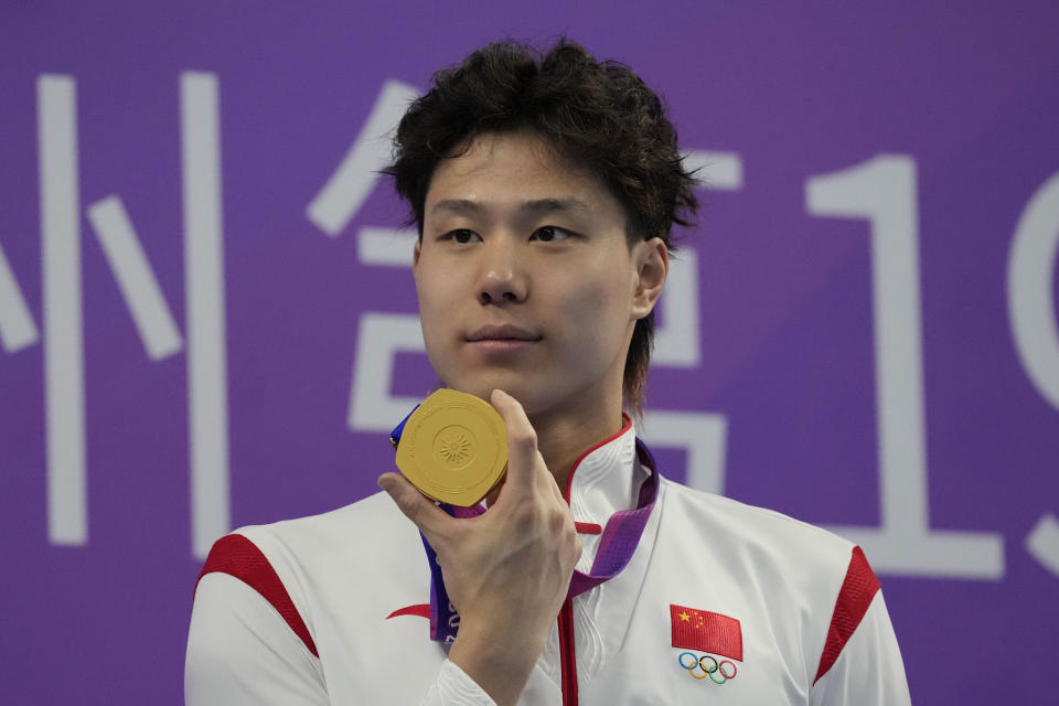 FILE - China's Qin Haiyang celebrates his gold medal for the men's 50m Breaststroke final at the 19th Asian Games in Hangzhou, China, on Sept. 29, 2023. (AP Photo/Aaron Favila, File)