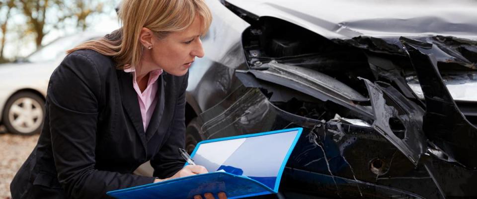 Car insurance adjuster at crash