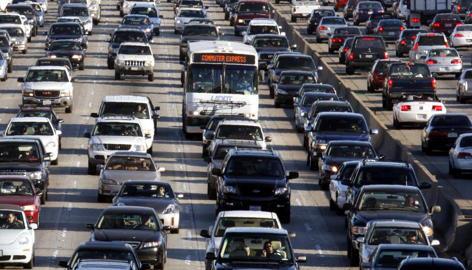 Seven rows of vehicles stalled to a standstill on a Los Angeles freeway.
