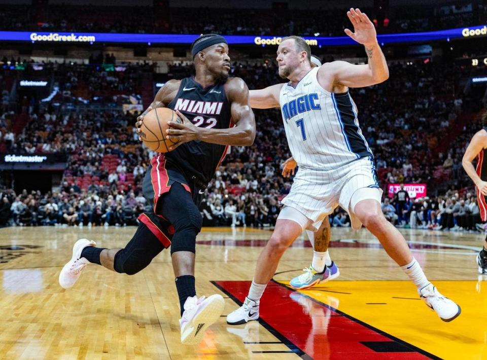 Miami Heat forward Jimmy Butler (22) goes up against Orlando Magic guard Joe Ingles (7) in the first half at the Kaseya Center in Miami, FL on Tuesday, February 6, 2024. Al Diaz/adiaz@miamiherald.com