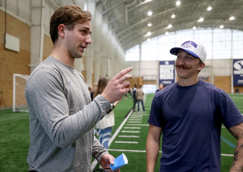 BYU quarterback Kedon Solvis talks with Skyler Mayne, BYU football director of sports science, after opening day of BYU spring football camp at the BYU Indoor Practice Facility in Provo, on Monday, March 6, 2023. | Kristin Murphy, Deseret News