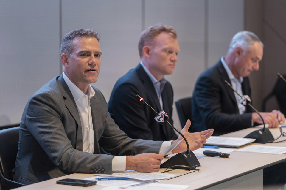 Former Boston Red Sox baseball executive Theo Epstein, left, speaks during a news conference at Major League Baseball's headquarters on Friday, Sept. 9, 2022. (AP Photo/Jeenah Moon)