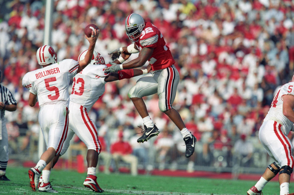 Oct 13, 2001; Columbus, OH, USA; Wisconsin Badgers quarterback Brooks Bollinger (5) throws with pressure from Ohio State Buckeyes linebacker Na’il Diggs (32) at Ohio Stadium. The Badgers beat the Buckeyes 20-17. Mandatory Credit: Matthew Emmons-USA TODAY Sports