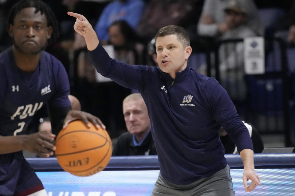 Merrimack head coach Joe Gallow calls to his players during the first half of Northeast Conference men's NCAA college basketball championship game against Fairleigh Dickinson, Tuesday, March 7, 2023, in North Andover, Mass. (AP Photo/Charles Krupa)