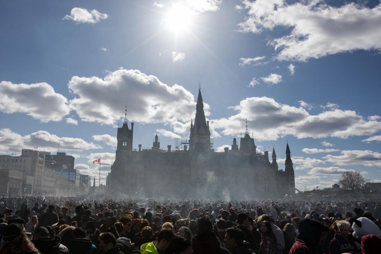 Smoke lingers over Parliament Hill as people smoke marijuana during the annual 4/20 rally on Parliament Hill in Ottawa, Ontario: LARS HAGBERG/AFP/Getty Images
