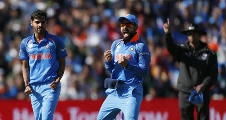 Britain Cricket - India v Pakistan - 2017 ICC Champions Trophy Group B - Edgbaston - June 4, 2017 India’s Bhuvneshwar Kumar (top) celebrates taking the wicket of Pakistan’s Ahmed Shehzad with India’s Virat Kohli Action Images via Reuters / Andrew Boyers Livepic