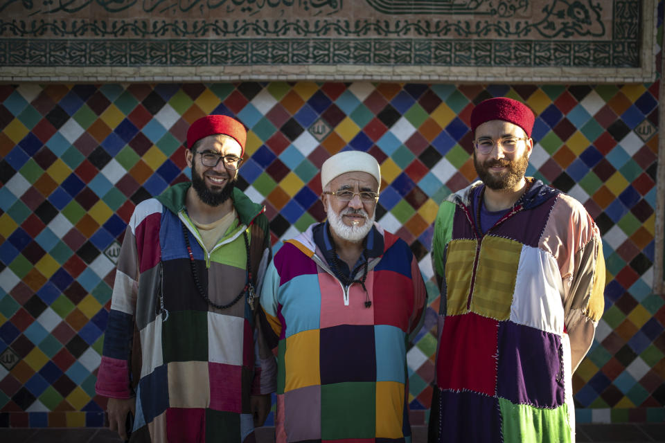 Anwar El Jadi, center, and his two sons, members of the Sufi Karkariya order pose for a portrait during a religious celebration to mark the birthday of the prophet Muhammed, in Aroui, near Nador, eastern Morocco, Monday, Oct. 18, 2021. (AP Photo/Mosa'ab Elshamy)