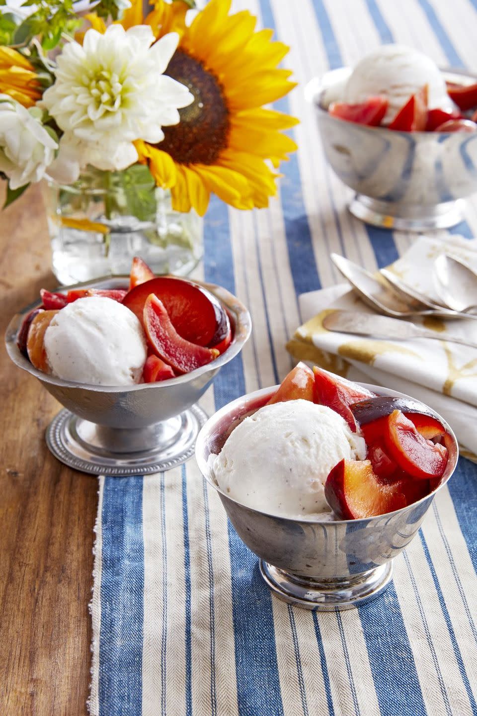 small metal bowls with vanilla ice cream and pickled gingery plums