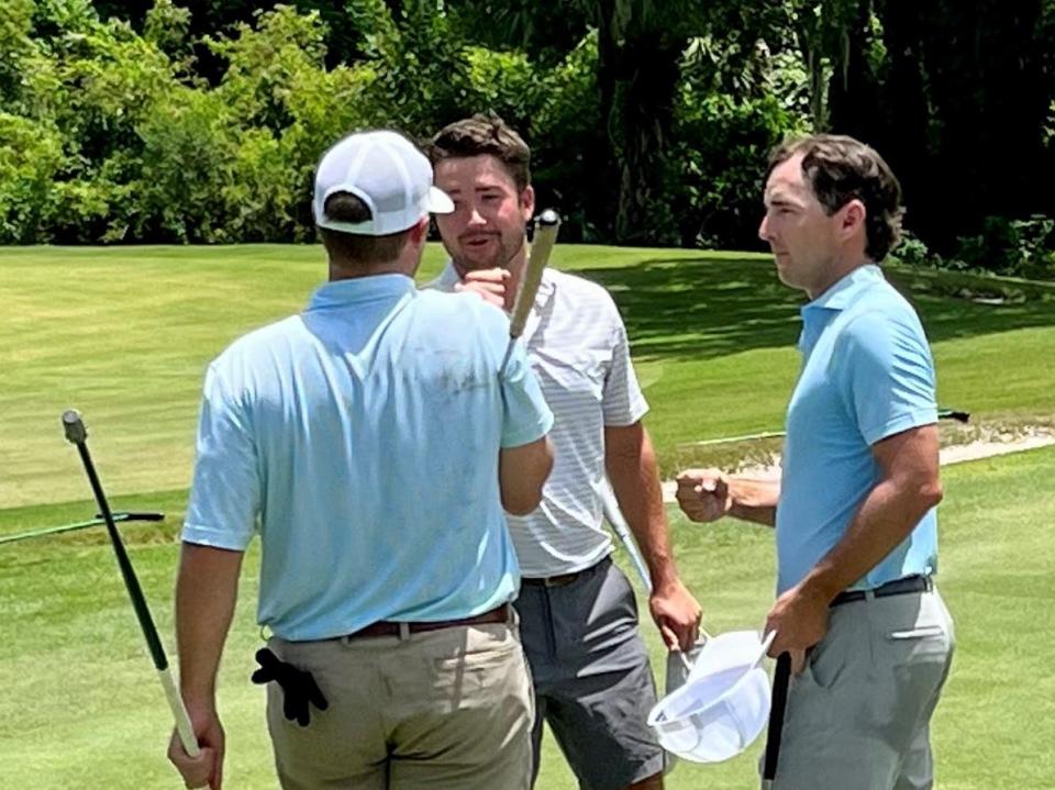 Johnny Watts (center) shakes hands with playing partners Mike Smith (left) and Tyler Brown (right) after finishing the second round of the Jacksonville Amateur with a 67 on Friday at the Deerwood Country Club.