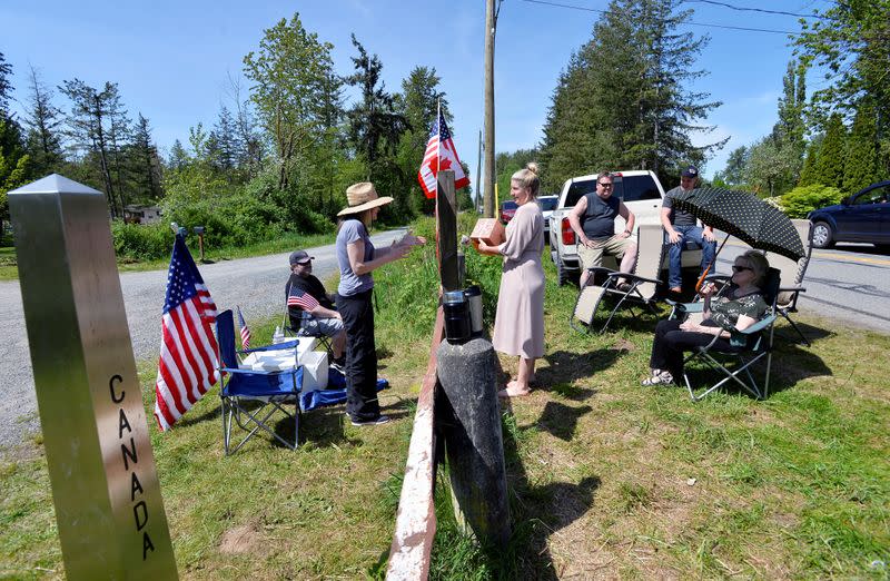 FILE PHOTO: Roadside meetups along the Canada-U.S. border in Langley, British Columbia.