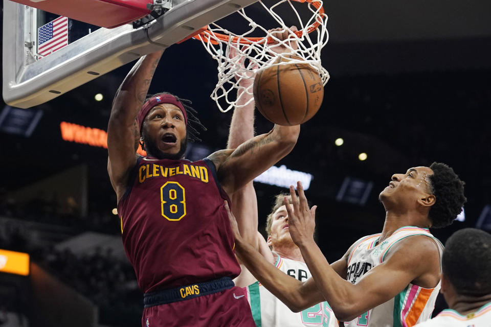 Cleveland Cavaliers forward Lamar Stevens (8) scores over San Antonio Spurs guard Devin Vassell (24) during the first half of an NBA basketball game, Friday, Jan. 14, 2022, in San Antonio. (AP Photo/Eric Gay)