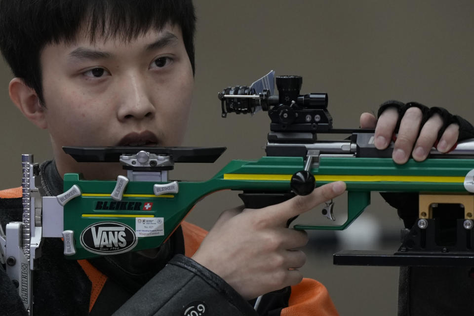 Du Linshu of China pauses during shooting on the way to win the gold medal at the Shooting 50m Rifle 3 Positions Men's Final for the 19th Asian Games in Hangzhou, China, Friday, Sept. 29, 2023. (AP Photo/Ng Han Guan)