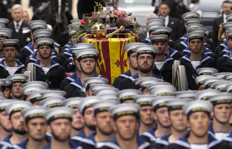 Service members surround Queen Elizabeth II's coffin.