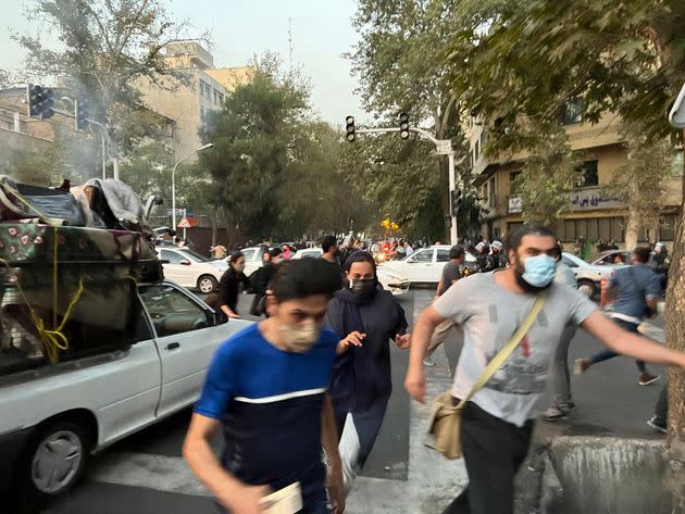 In this Monday, Sept. 19, photo taken by an individual not employed by The Associated Press and obtained by the AP outside Iran, people run away from anti-riot police during a protest over the death of a young woman who had been detained for violating the country's conservative dress code, in downtown Tehran. (Photo: AP)