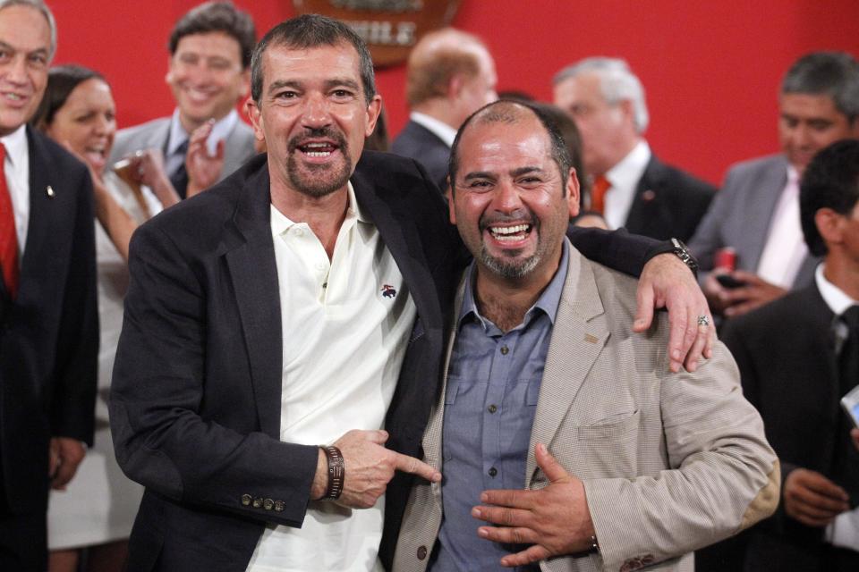 FILE - In this Jan. 31, 2014 file photo, Spain's actor Antonio Banderas, left, poses for photos with rescued miner Mario Sepulveda in Santiago, Chile. Sepulveda is one of the 33 miners who was trapped in a mine cave-in, in Chile's Atacama desert in 2010. Banderas will play Sepulveda, who became the public face of the miners and known as "Super Mario," in the film "The 33" which is expected to be released next year. (AP Photo/Luis Hidalgo, File)