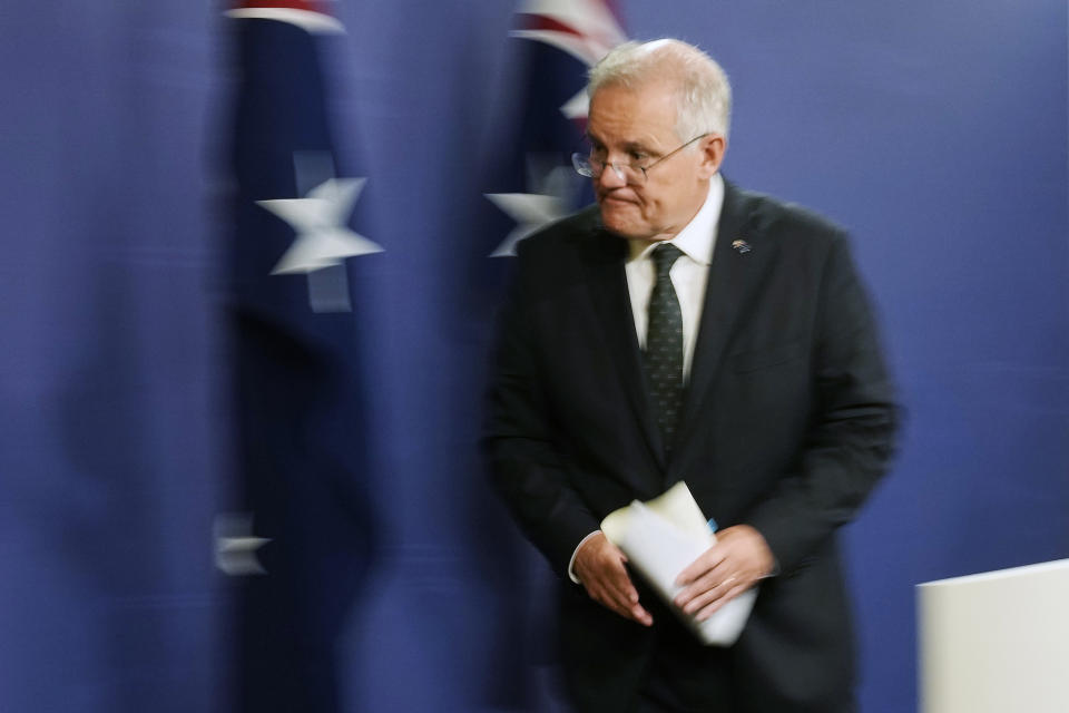 Australian Prime Minister Scott Morrison leaves a news conference in Sydney after talking about the situation in Ukraine, Wednesday, Feb. 23, 2022. Australia has announced additional sanctions on Russia and is warning businesses to prepare for retaliation through Russian cyberattacks. Morrison said Wednesday that targeted financial sanctions and travel bans will be a first batch of measures in response to Russian aggression toward Ukraine. (AP Photo/Rick Rycroft)
