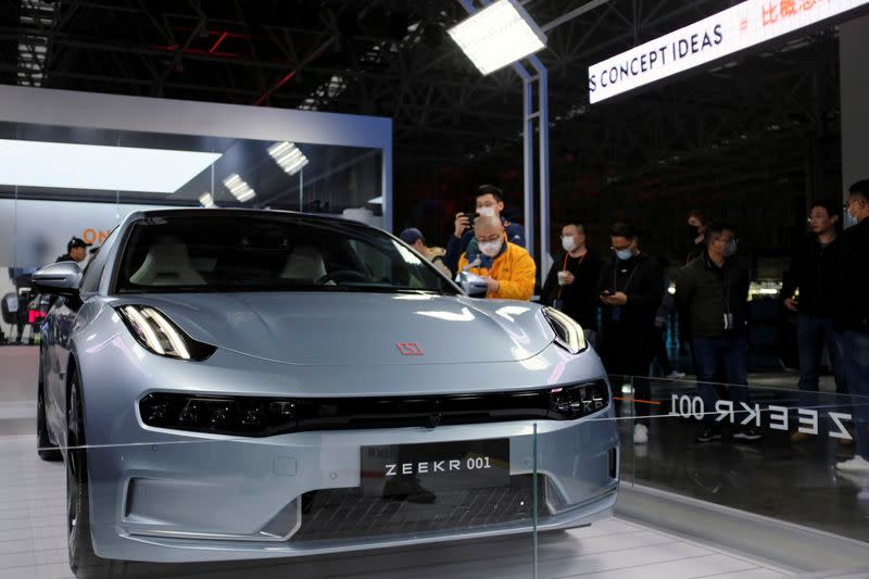 Visitors check a Zeekr 001, a model from Geely's new brand Zeekr, at its factory in Ningbo