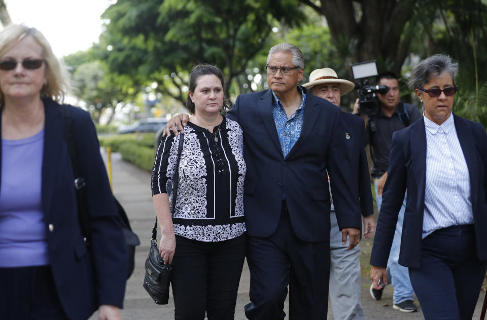 Former deputy prosecutor Katherine Kealoha, center left, and husband, former Honolulu police chief Louis Kealoha, center right, walk toward Queen Street after the verdict in their corruption case at federal court Thursday, June 27, 2019, in Honolulu. A jury has found the former Honolulu prosecutor and her now-retired police chief husband guilty in a plot to frame a relative to silence him from revealing fraud that financed their lavish lifestyle, a case that shook the top levels of law enforcement. (Cindy Ellen Russell/Honolulu Star-Advertiser via AP)