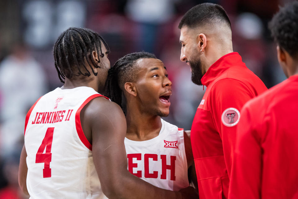 LUBBOCK, TX - JANUARY 07: Guard Lamar Washington #1 of the Texas Tech Red Raiders celebrates with forward Robert Jennings #4 and Fardaus Aymaq during the second half of a college basketball game against the Oklahoma Sooners at United Supermarkets Arena on January 07, 2023.  In Lubbock, Texas.  (Photo by John E. Moore III/Getty Images)