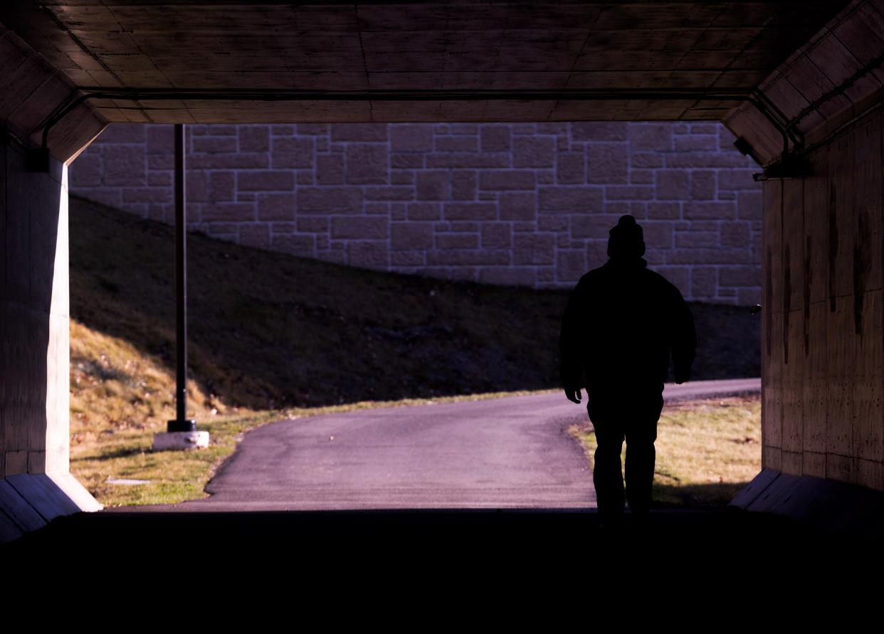 A walker heads through the underpass connecting North Park and Jackson High School in Jackson Township.