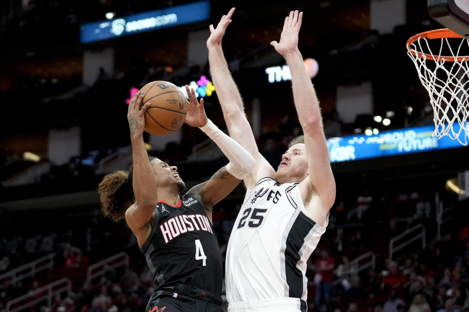 Houston Rockets guard Jalen Green (4) shoots as San Antonio Spurs center Jakob Poeltl defends during the second half of an NBA basketball game, Monday, Dec. 19, 2022, in Houston. (AP Photo/Eric Christian Smith)