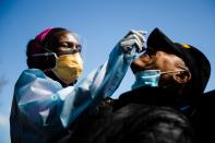 Dr. Ala Stanford administers a COVID-19 swab test on Wade Jeffries in the parking lot of Pinn Memorial Baptist Church in Philadelphia on April 22, 2020. Stanford and other doctors formed the Black Doctors COVID-19 Consortium to offer testing and help address health disparities in the African American community.