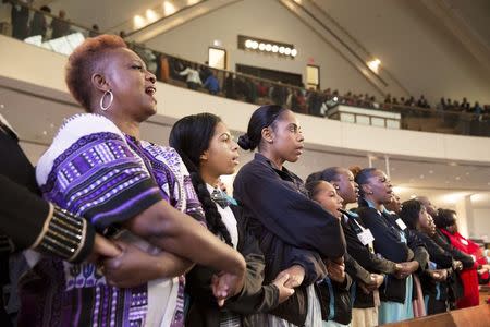 People sing "We Shall Overcome" at the conclusion of The King Center's 47th Annual Martin Luther King Jr. Commemorative Service in Atlanta January 19, 2015. REUTERS/Christopher Aluka Berry