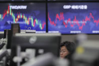 A currency trader watches computer monitors at the foreign exchange dealing room in Seoul, South Korea, Friday, Oct. 18, 2019. Share prices retreated in Asia after China reported Friday that its economy grew at an annual rate of 6.0% in the latest quarter. (AP Photo/Lee Jin-man)