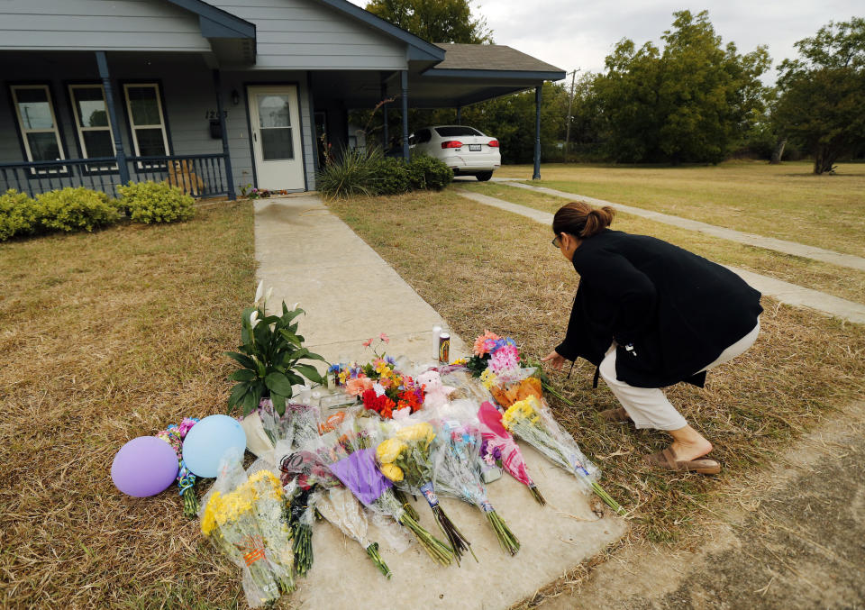 Anastasia Gonzalez, of Burleson, Texas, leaves a flowers on the front sidewalk of Atatiana Jefferson's home on E. Allen Ave in Fort Worth on Oct. 15, 2019. | Tom Fox—The Dallas Morning News/AP