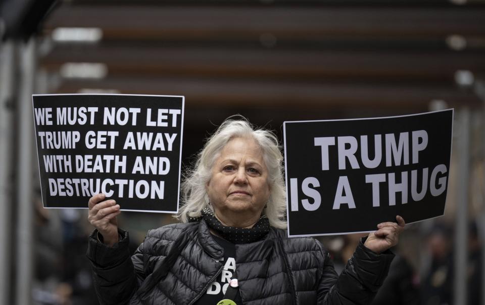 Demonstrators protest against former President Donald Trump near Mr Bragg's office - Getty