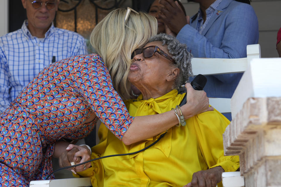 Opal Lee, right, gets a hug from Fort Worth Mayor Mattie Parker outside Lee's new house in Fort Worth, Texas, Friday, June 14, 2024. Habitat for Humanity built Lee the home on the same lot where as a child a white mob destroyed her family's home driving them away. (AP Photo/LM Otero)