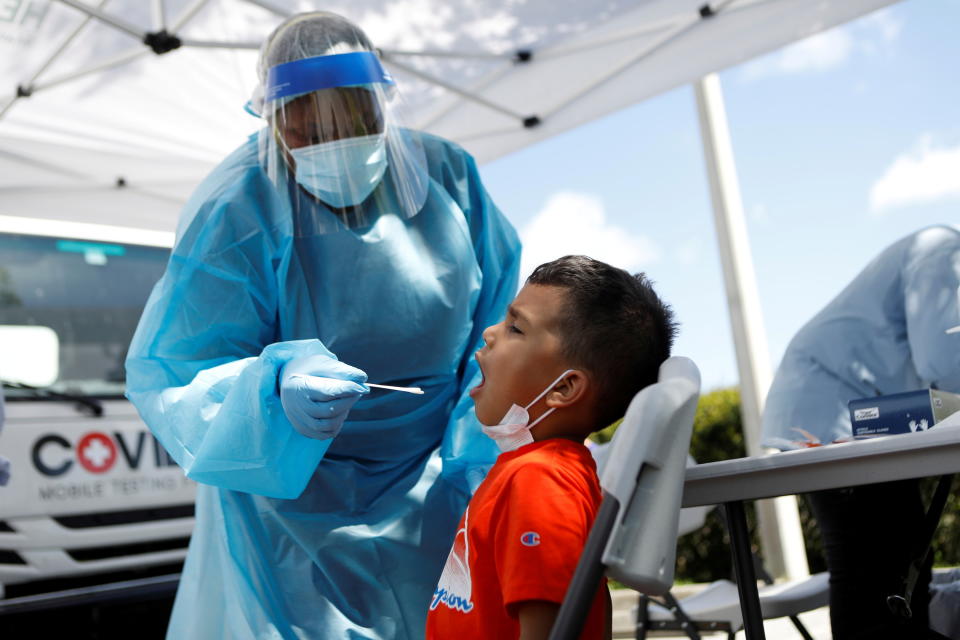 Josaphet Ramos, 8, gets a swab test by a healthcare worker at a COVID-19 mobile testing site hosted by the Manatee County Florida Department of Health in Palmetto, Florida, U.S., August 2, 2021.  REUTERS/Octavio Jones     TPX IMAGES OF THE DAY