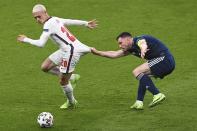 Scotland's Andrew Robertson, right, tries to stop England's Phil Foden during the Euro 2020 soccer championship group D match between England and Scotland, at Wembley stadium, in London, Friday, June 18, 2021. (Facundo Arrizabalaga/Pool via AP)