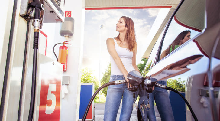 A photo of a woman pumping gass