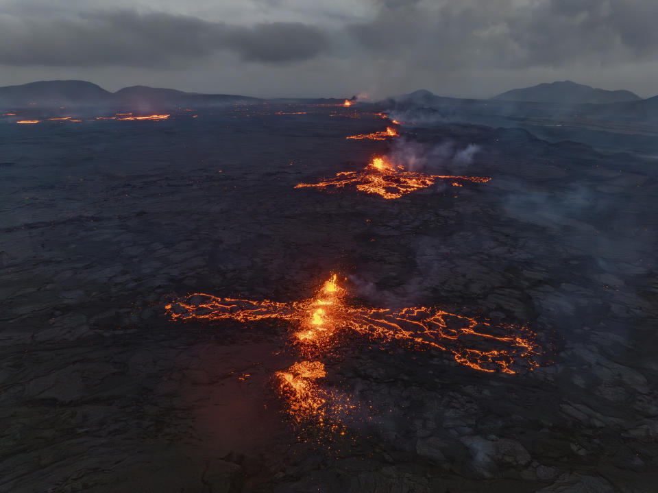 Eruptive fissures spew lava and smoke from a volcano in Grindavik, Iceland, Wednesday, May 29, 2024. A volcano in southwestern Iceland erupted Wednesday for the fifth time since December, spewing red lava that once again threatened the coastal town of Grindavik and led to the evacuation of the popular Blue Lagoon geothermal spa. (AP Photo/Marco di Marco)