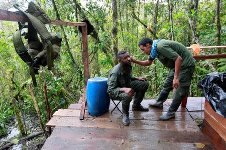 Members of the 51st Front of the Revolutionary Armed Forces of Colombia (FARC) have a haircut and a beard shave at a camp in Cordillera Oriental, Colombia, August 16, 2016. REUTERS/John Vizcaino