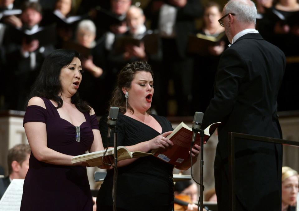 Soloists Sahoko Sato Timpone, mezzo-soprano, left, and Robyn Marie Lamp, soprano, perform under the direction of Conductor Chris Shepard  at Mechanics Hall on  March 31, 2019.