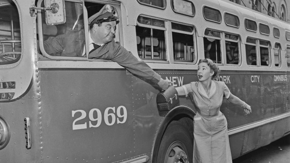 Man driving bus woman chasing it; best tv couples