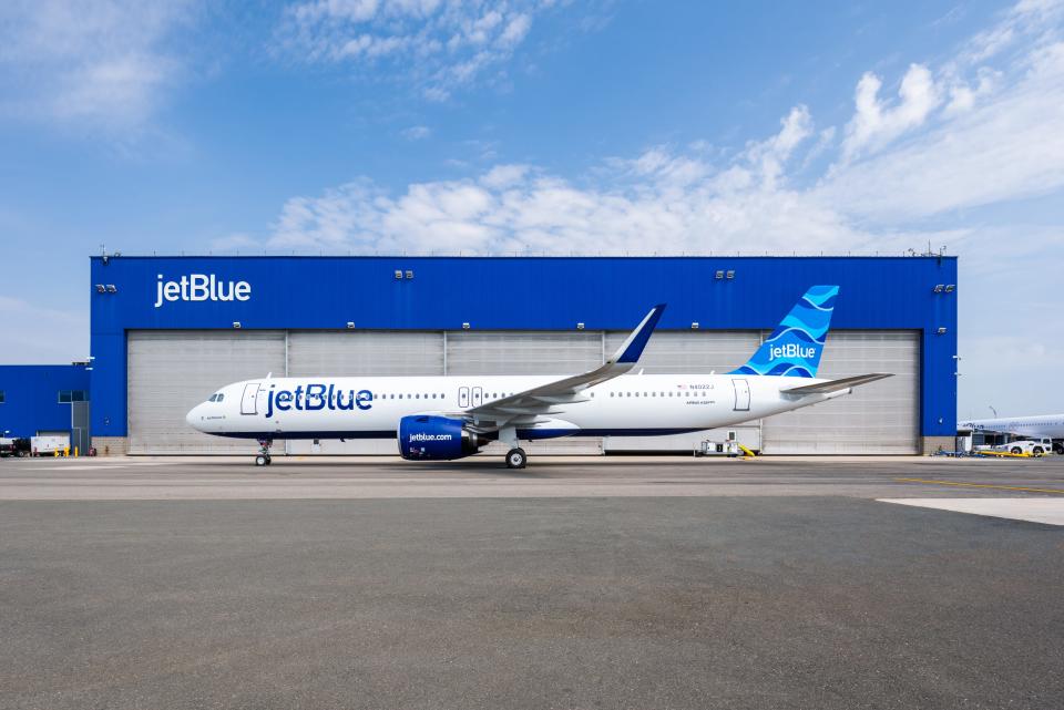 A JetBlue Airbus A321LR outside of one of the airline's hangars.